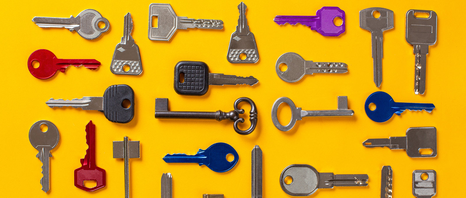 photo of lots of different keys, in different orientations, laid out on a yellow surface