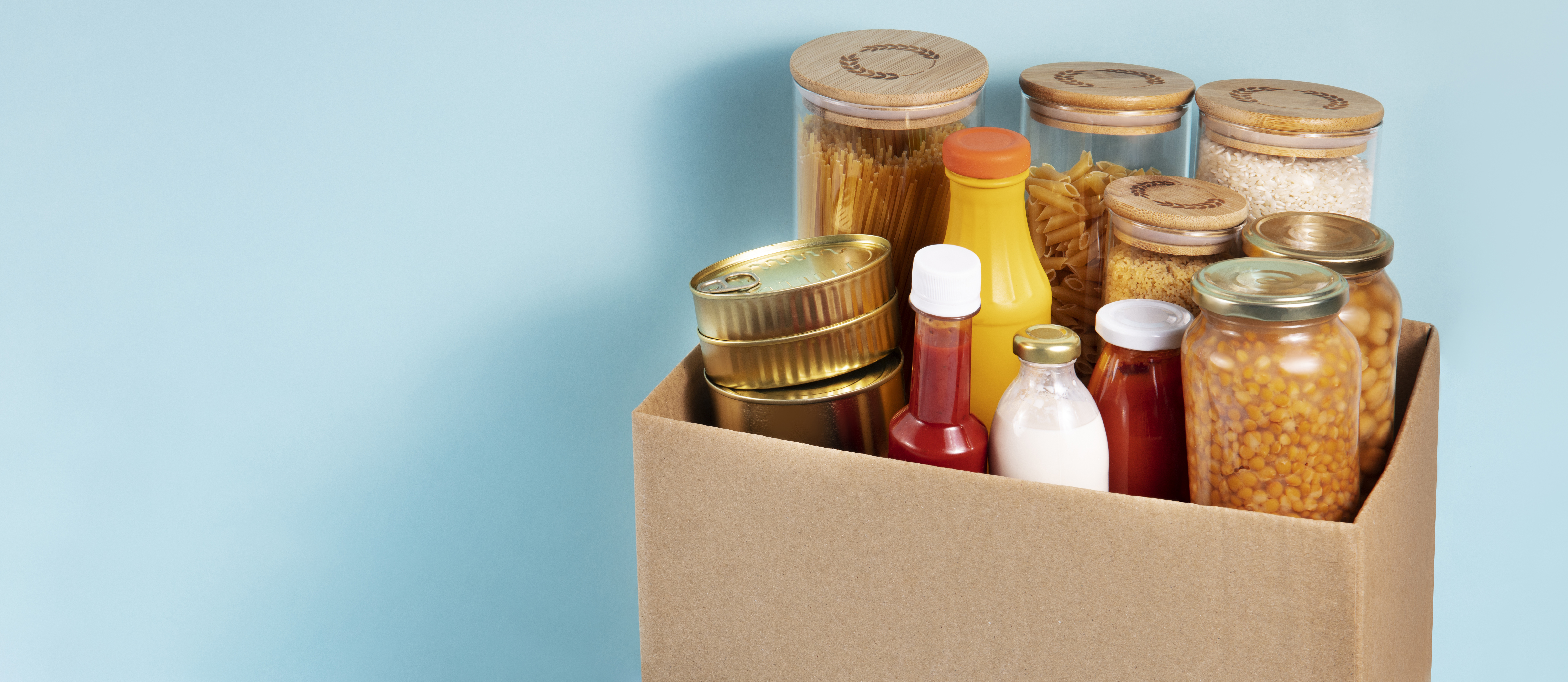 Cardboard box full of dried food goods and condiments