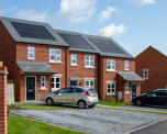 Row of three houses with solar panels on top
