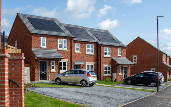 Row of three houses with solar panels on top