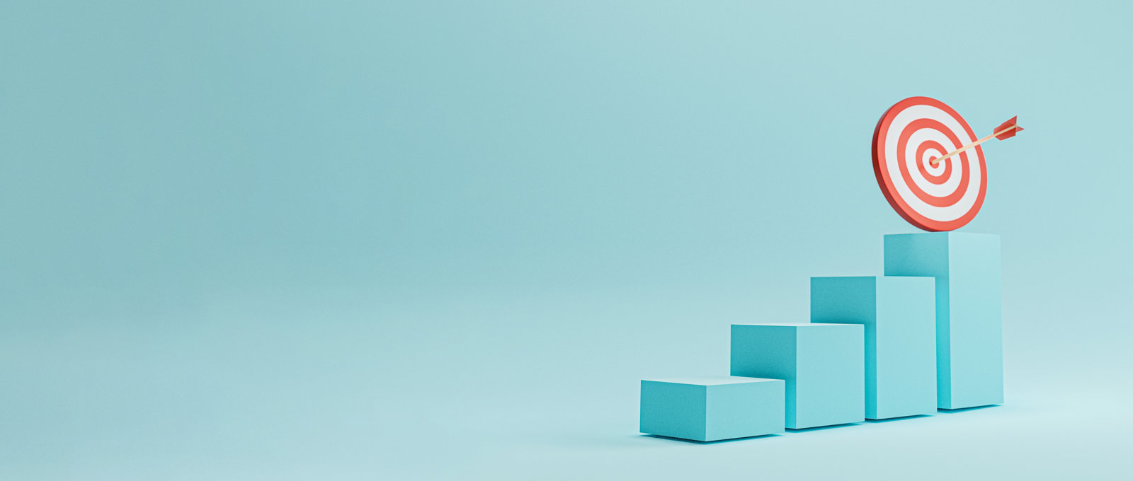 Photo of a 3 dimensional bar chart made of turquoise blocks increasing in height from left to right. Above the highest block is a target with an arrow stuck right in the centre.