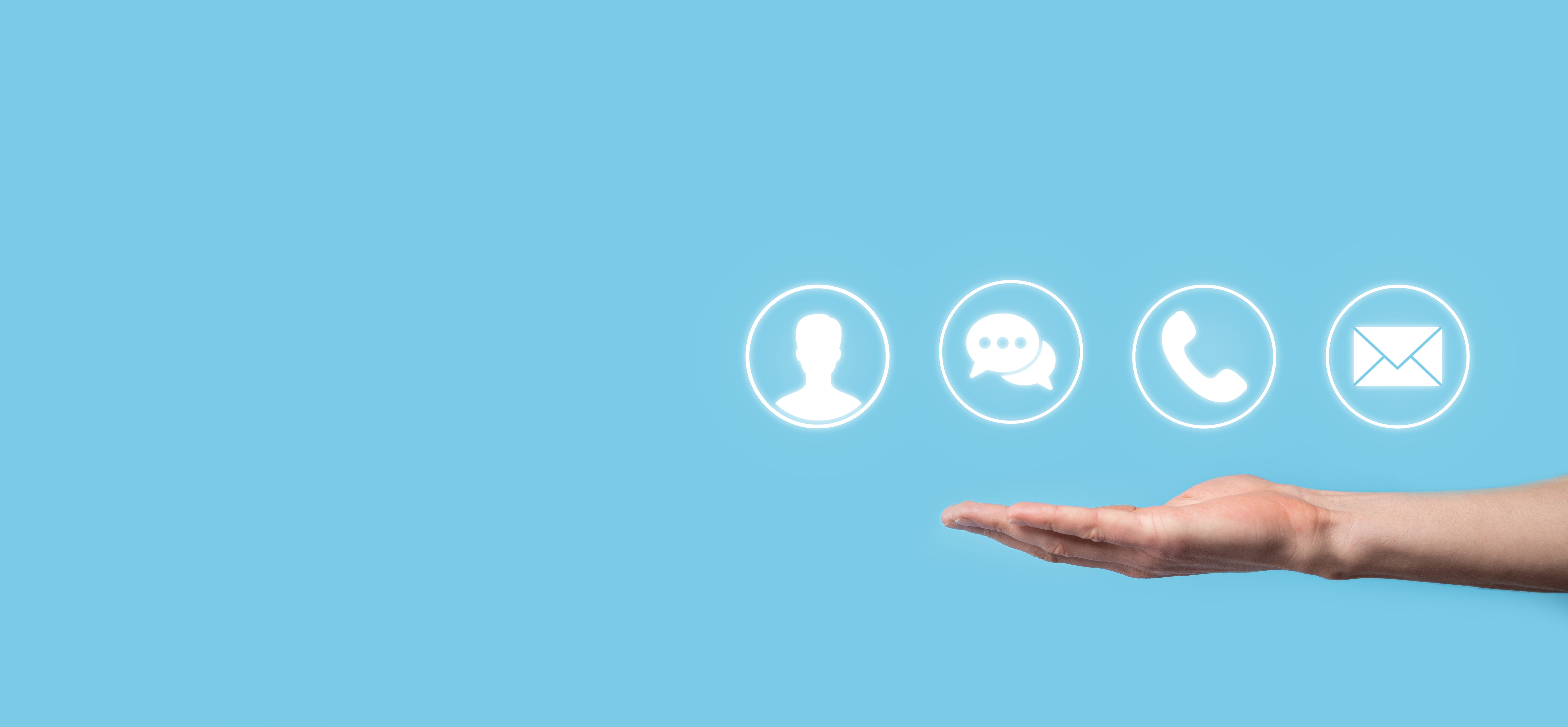 Photo of an arm extended against a light blue background. Above the open palm are four graphic symbols showing a person's silhouette, speech bubbles, a telephone handset and an envelope