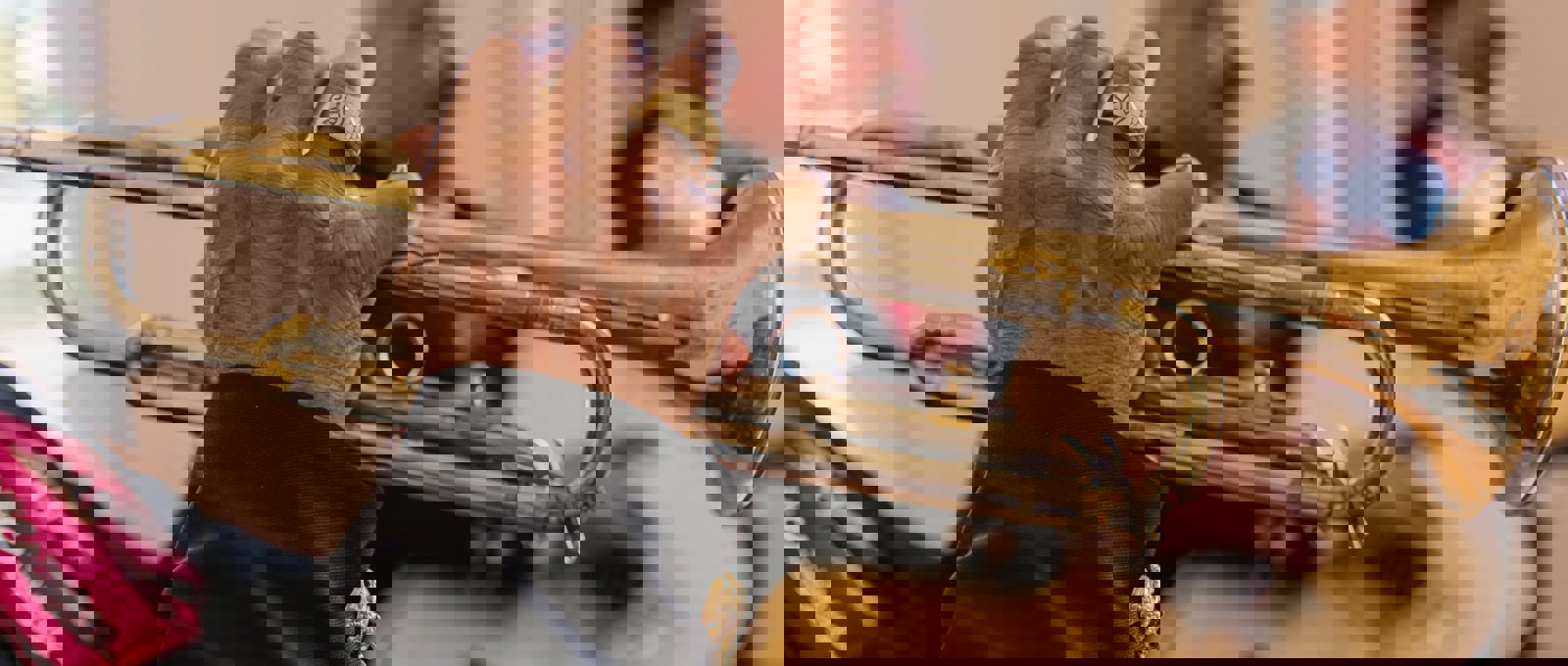 A man in a black shirt playing the trumpet.