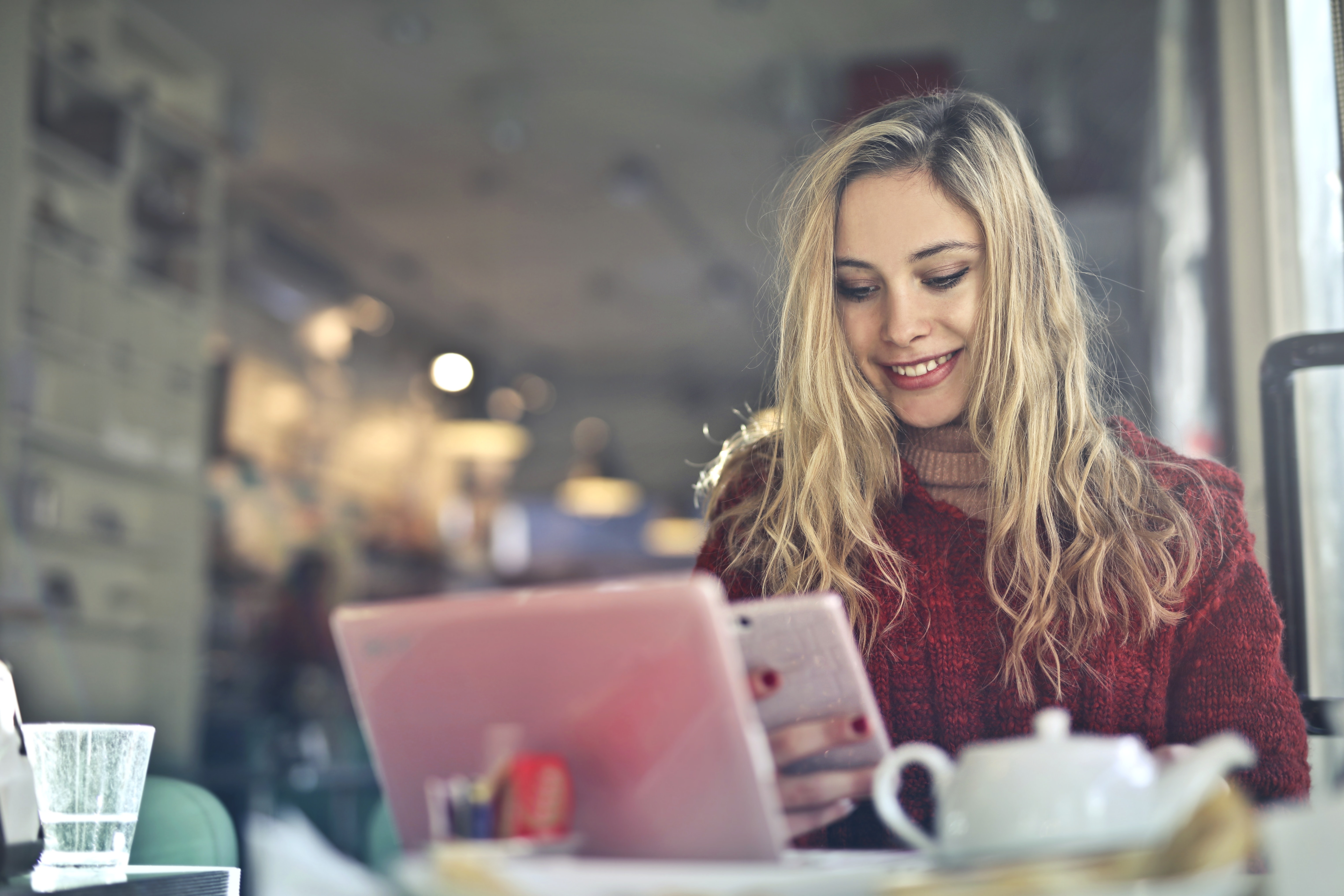 Woman Working On A Laptop In A Cafe