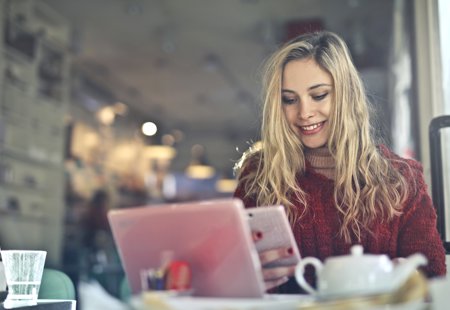 Woman Working On A Laptop In A Cafe