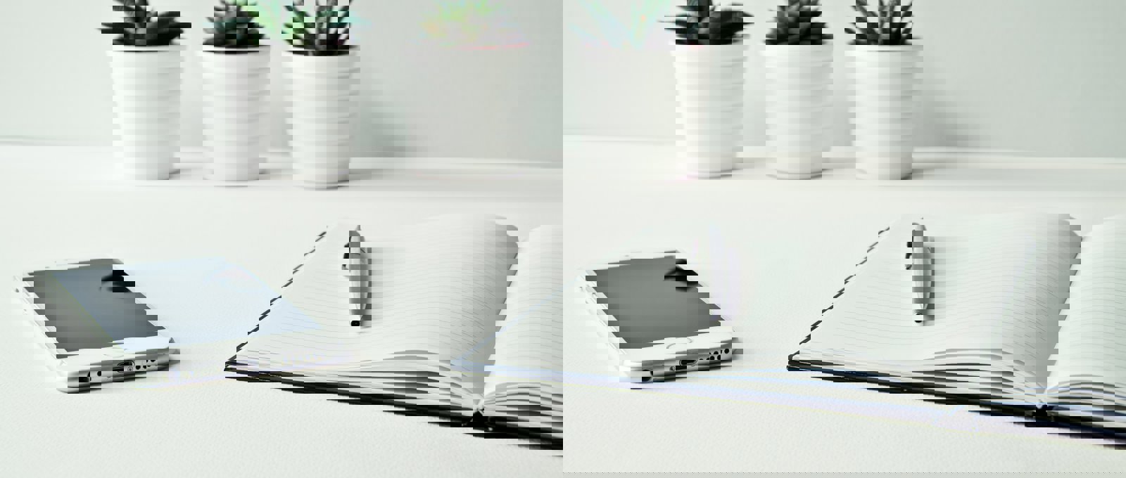 A notebook and pen sit on a white desk beside an iPhone and three small succulents in white pots.