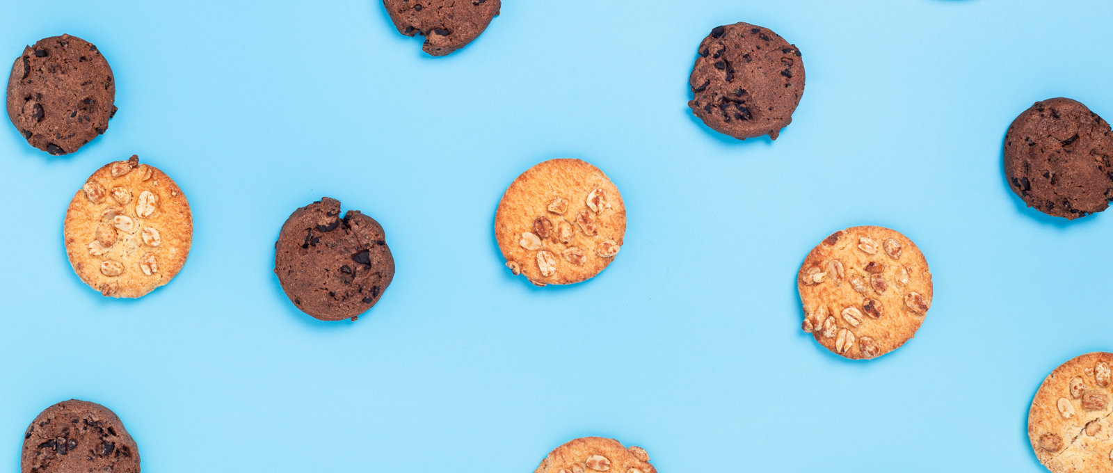 Photograph of different kinds of cookies on a blue surface