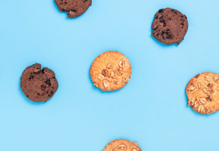 Photograph of different kinds of cookies on a blue surface