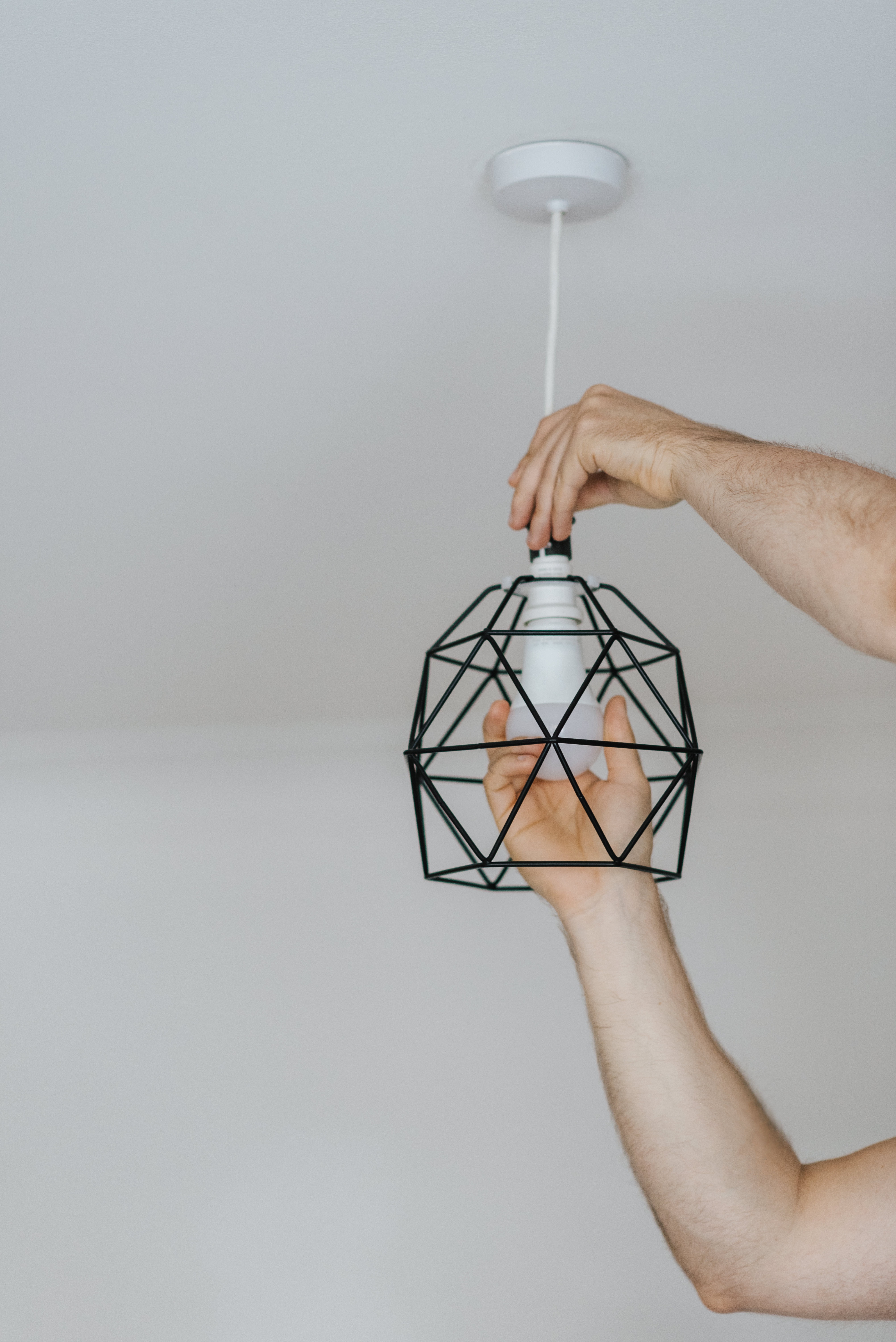 A close up of a man changing a light bulb