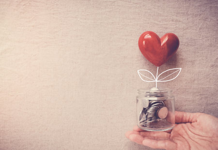 Hand Holding Jar Heart Tree Growing Money Coins