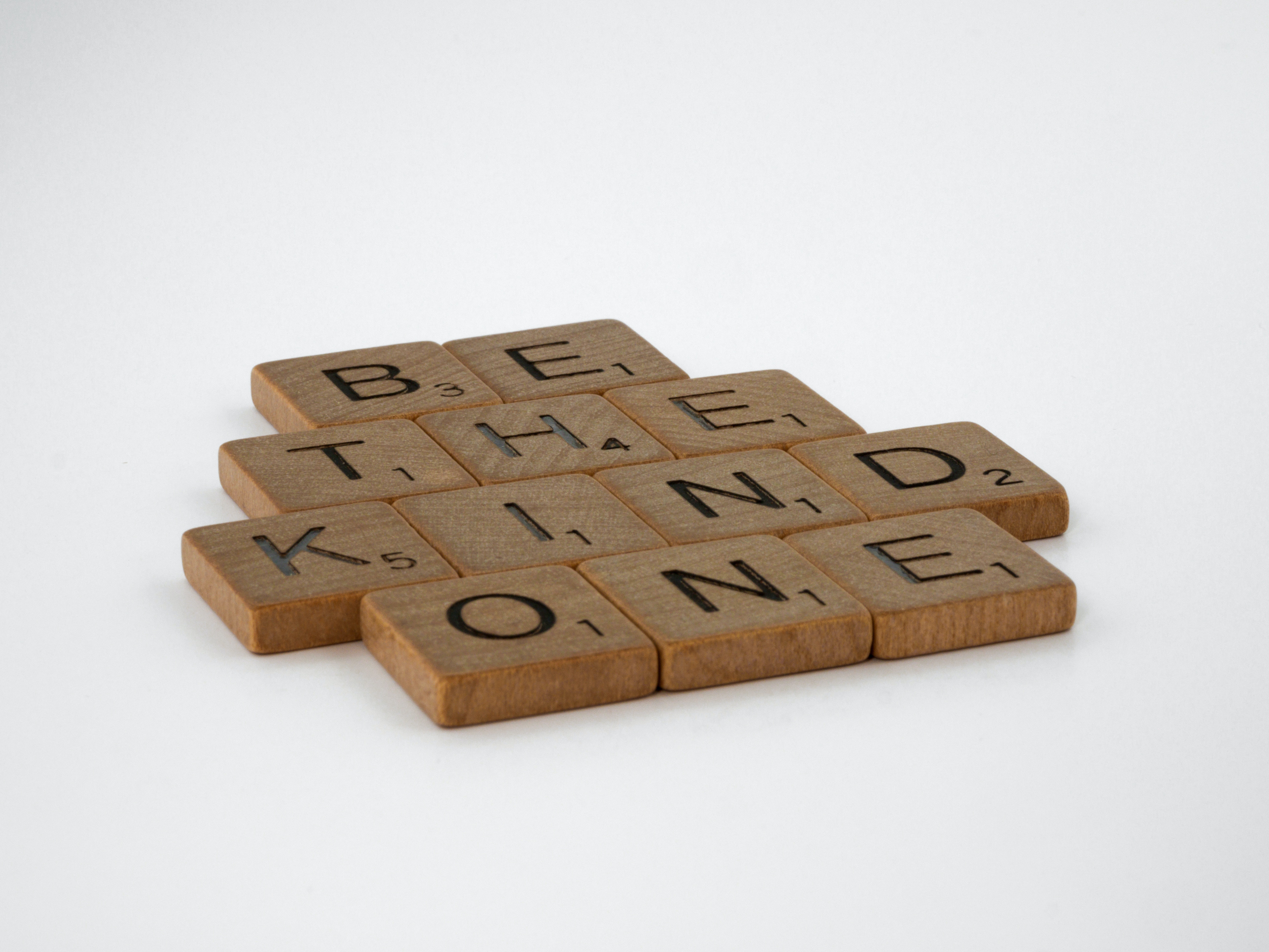 Photograph of wooden tiles spelling out 'Be the kind one'
