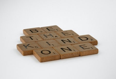 Photograph of wooden tiles spelling out 'Be the kind one'