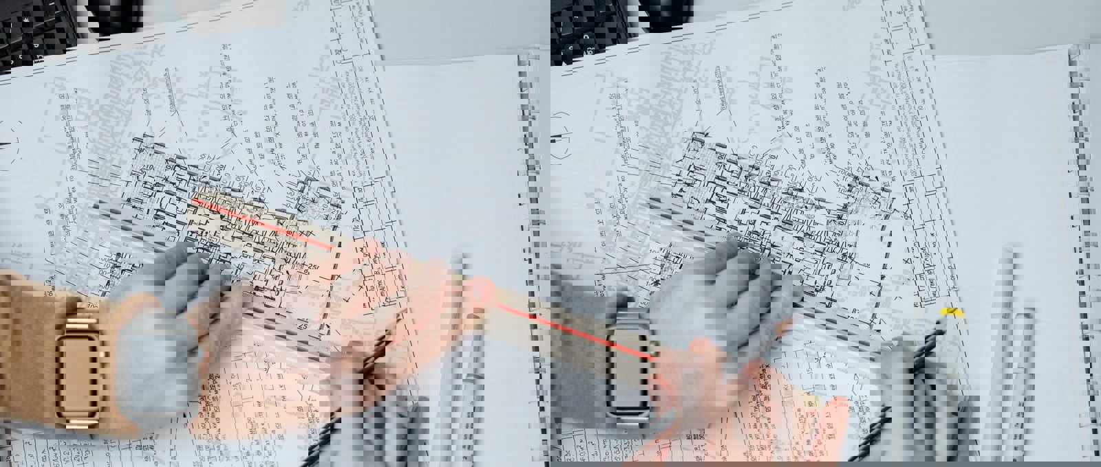 Close up photograph of someone working on architectural blueprints