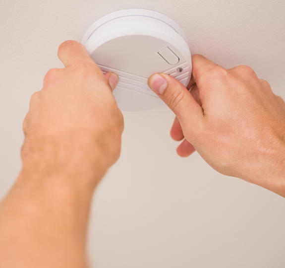 Handyman Installing Smoke Detector