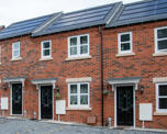 Row of terraced homes with solar panels on