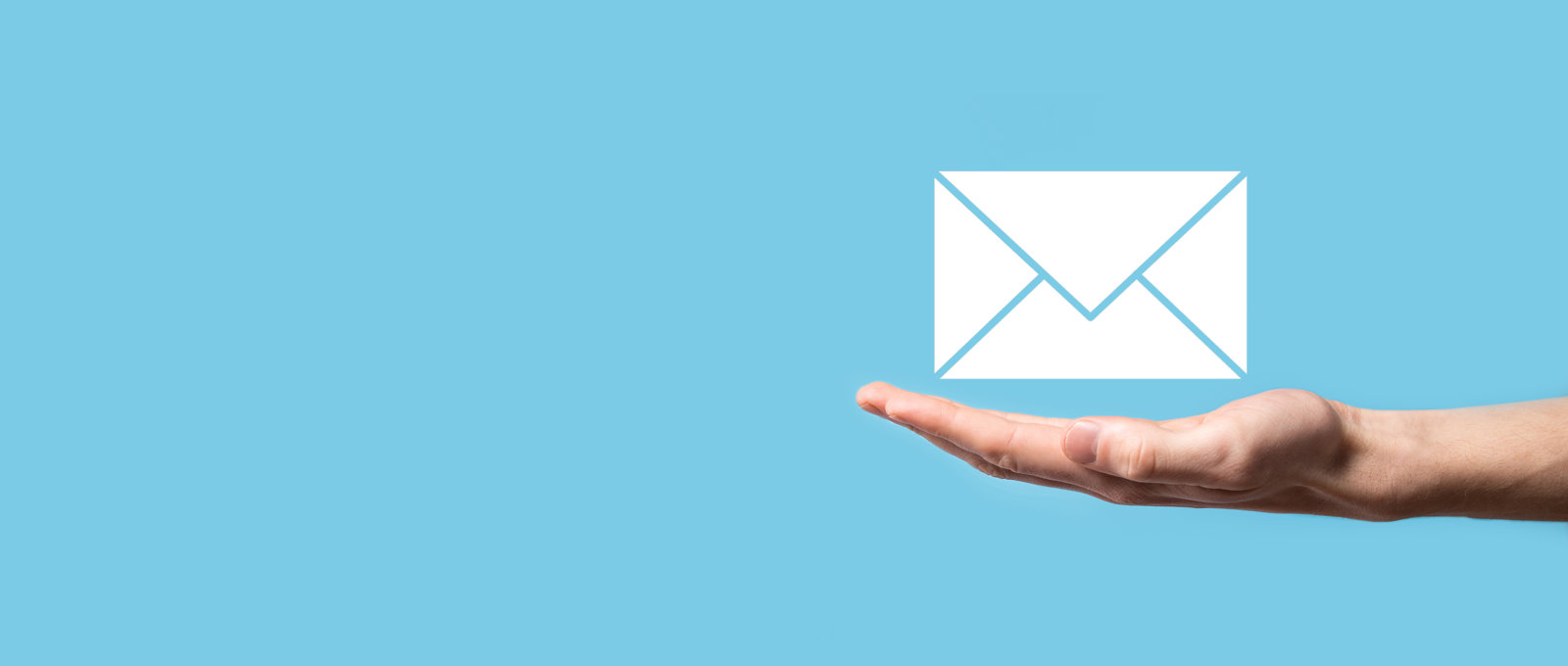 Photo of a hand being held out palm-up in front of a pale blue backround. An icon of an envelope is floating over the hand