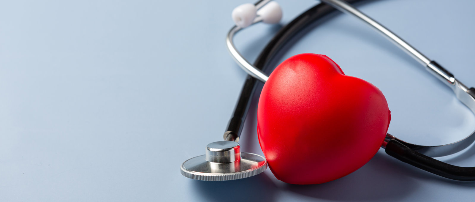 Stethoscope next to a red 3D love heart
