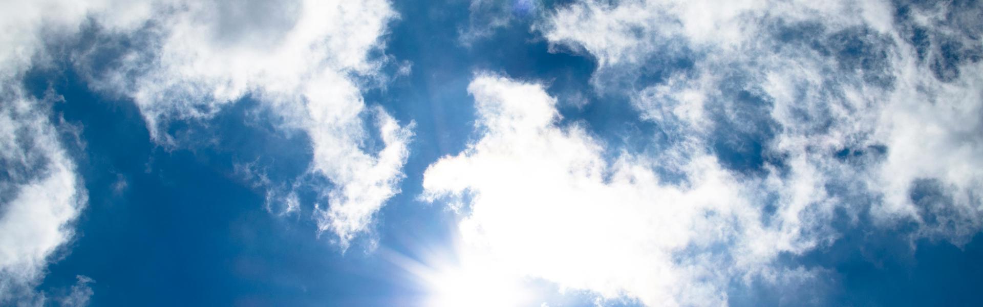A bright blue sky with light cloud coverage