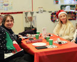 Photo of people sitting around a table with Christmas decorations on