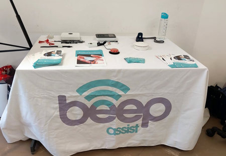 Photo of various products used by Beep Assist arranged on a display table.