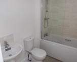Photo of a sink, toilet and bath with shower