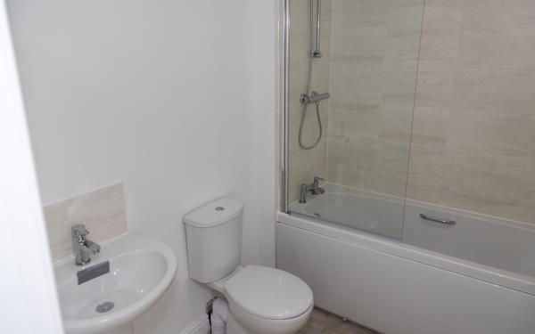 Photo of a sink, toilet and bath with shower