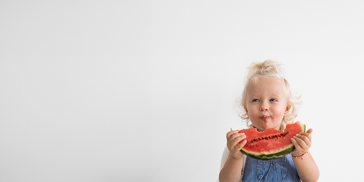 Little Girl Eating A Watermelon