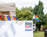 A canvas reading 'how can your community feel more inclusive', surrounded by Pride flags 