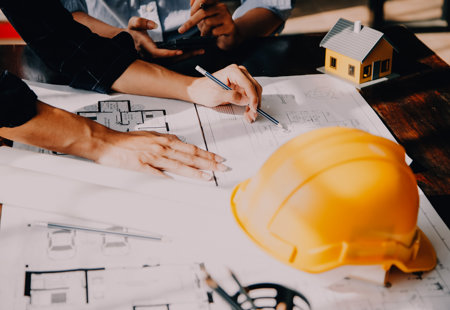 Two Specialists Inspect Commercial Industrial Building Construction Site Real Estate Project With Civil Engineer Investor Use Laptop Background Crane Skyscraper Concrete Form