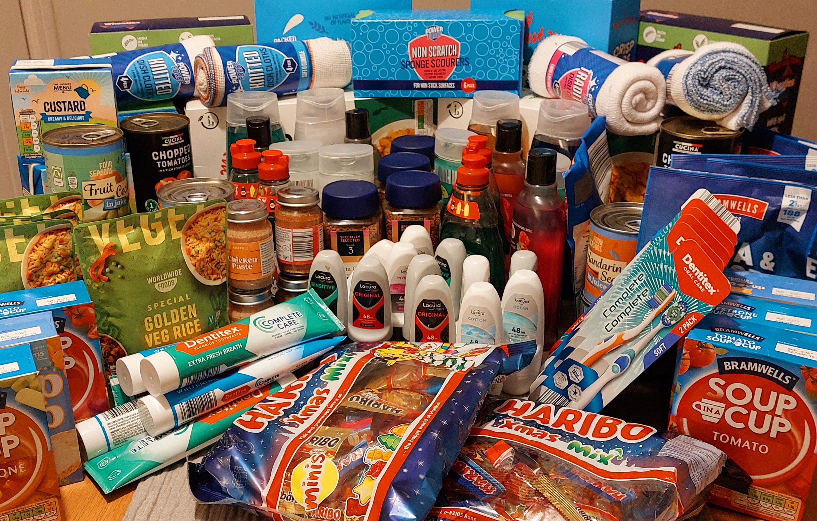 A photo of lots of food and toiletries on a table