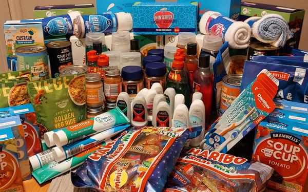 A photo of lots of food and toiletries on a table