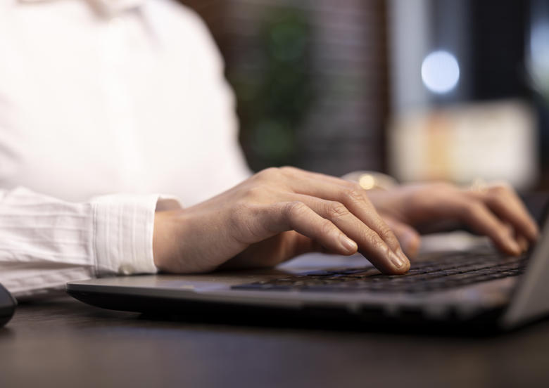 female employee typing with precision
