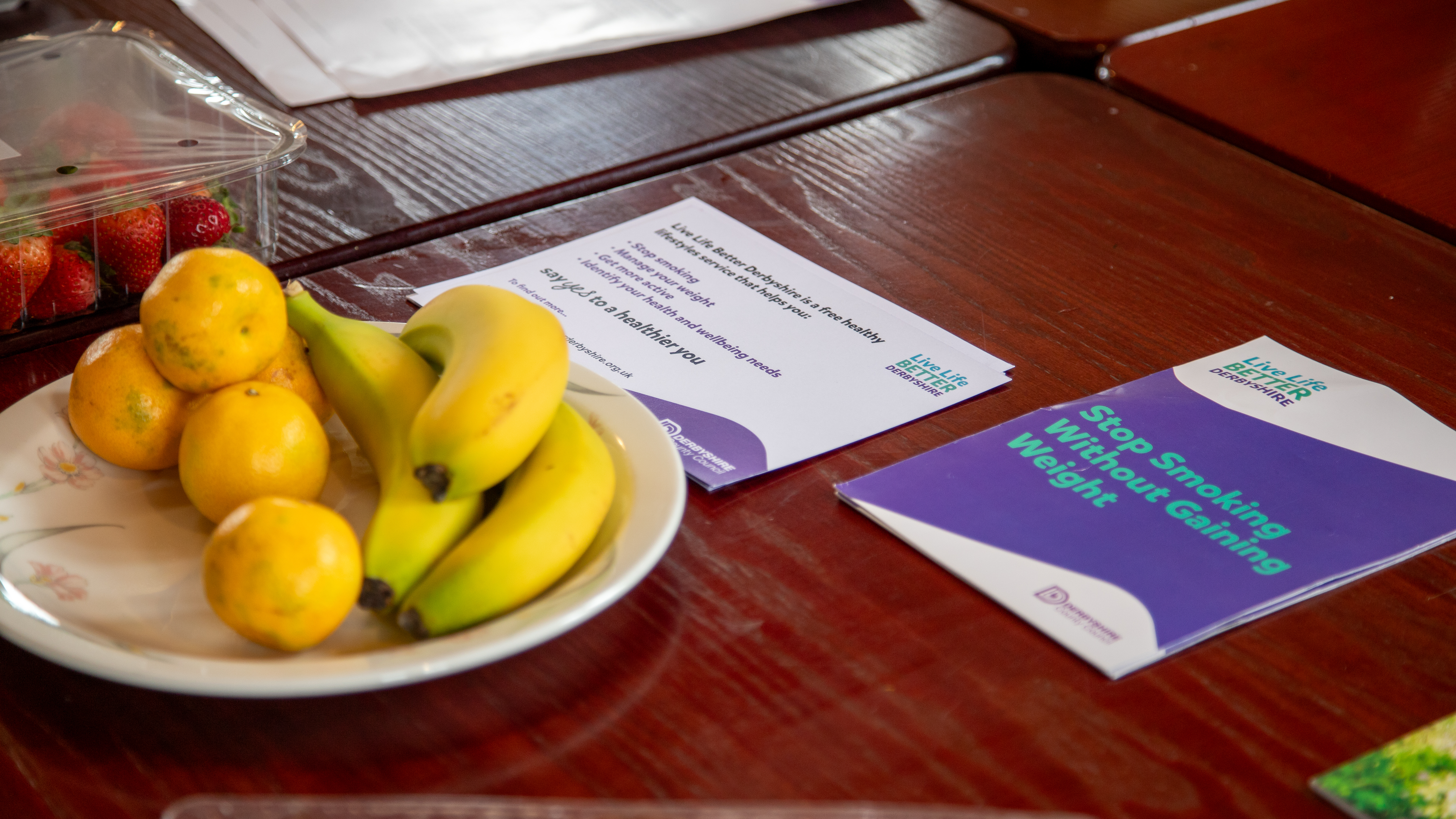 Live Life Better Derbyshire leaflets on a table with fruit