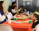 Photo of people sitting around a table with Christmas decorations on