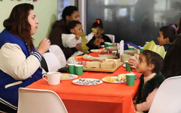 Photo of people sitting around a table with Christmas decorations on