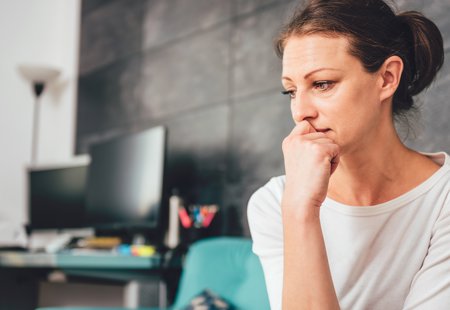 Sad Woman Sat On Sofa