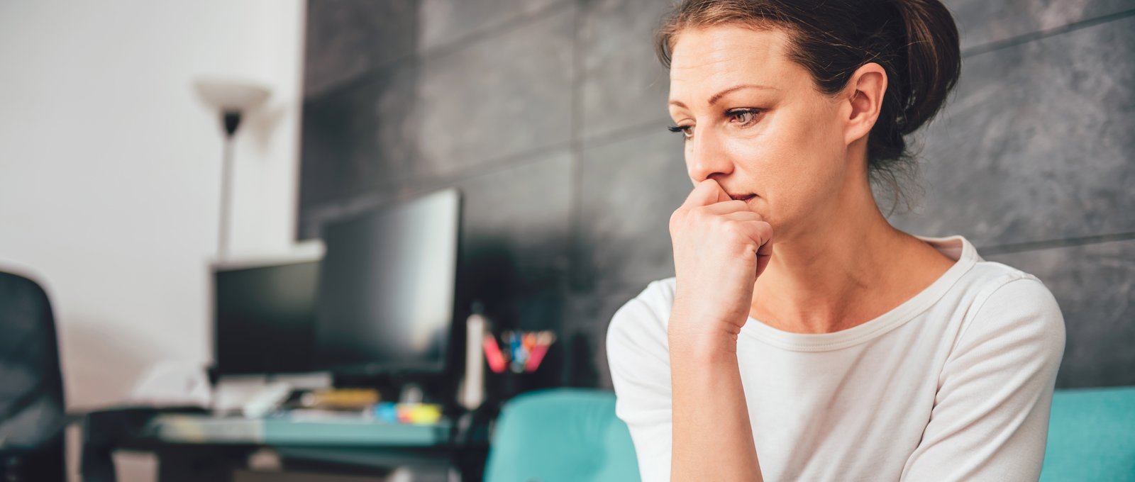 Sad Woman Sat On Sofa