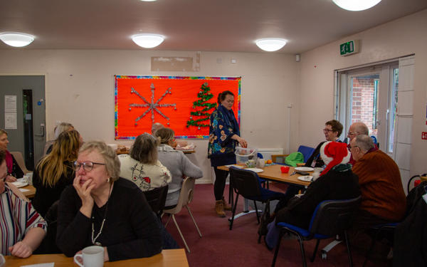 Elle leading the group in a game called floaty sinky, where objects are dropped in water