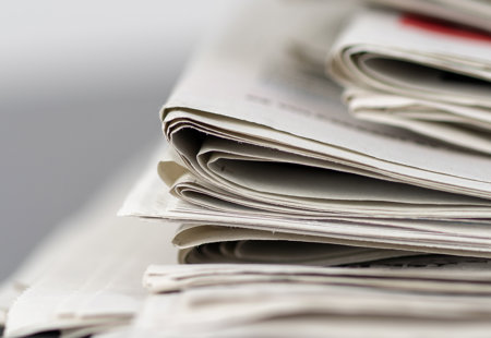 close-up photo of a stack of newspapers