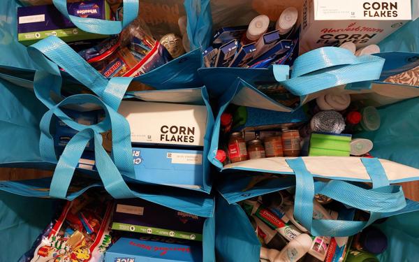 A photo looking down at shopping bags full of food and toiletries
