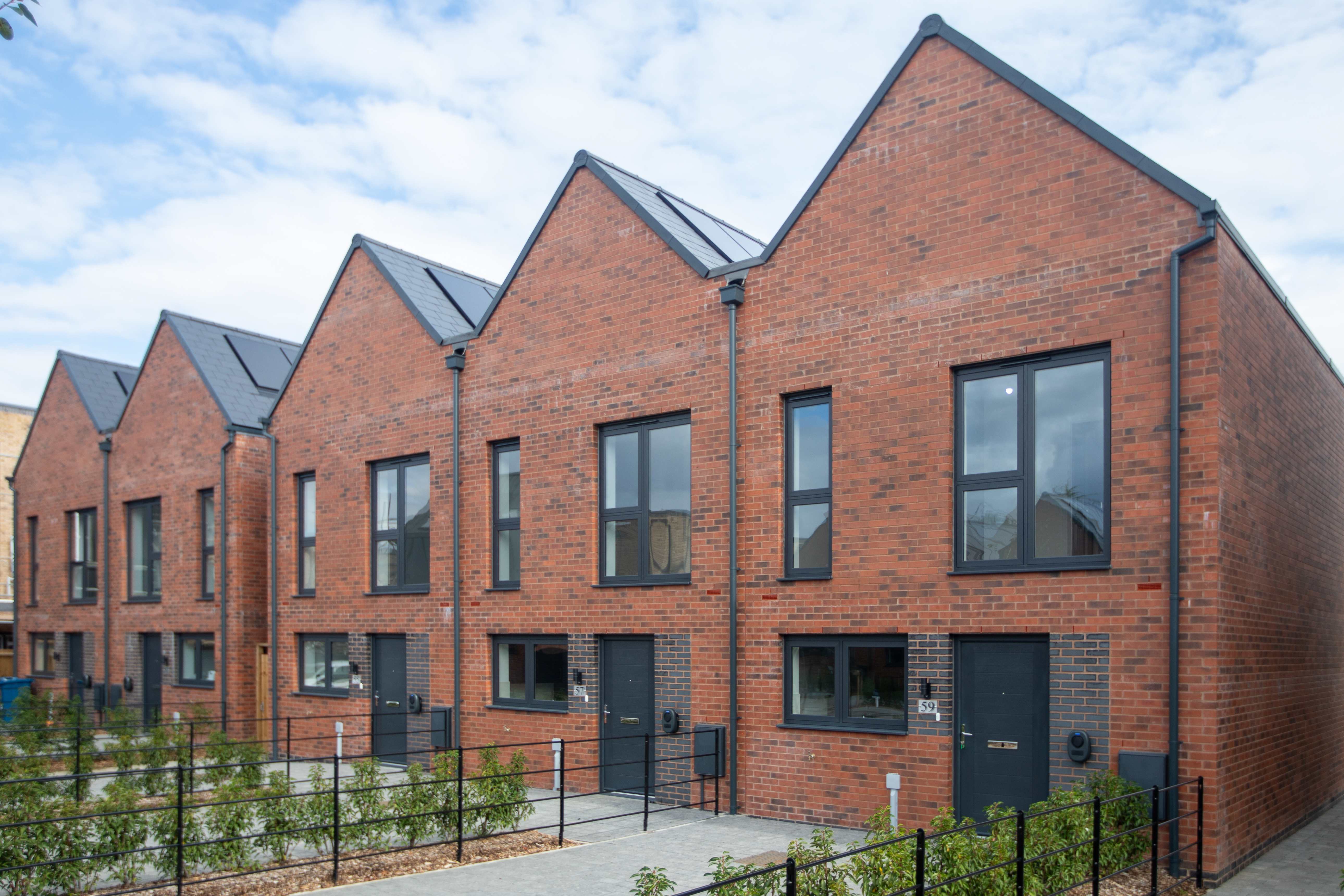 Row of five houses with solar panels on the roof