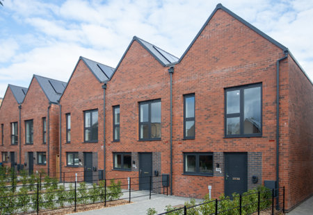 Row of five houses with solar panels on the roof