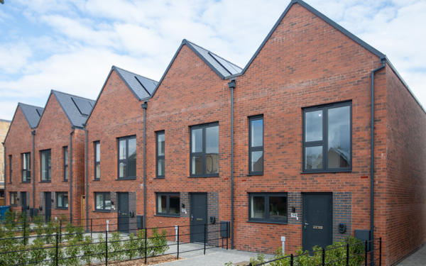 Row of five houses with solar panels on the roof