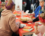 Photo of people sitting around a table with Christmas decorations on