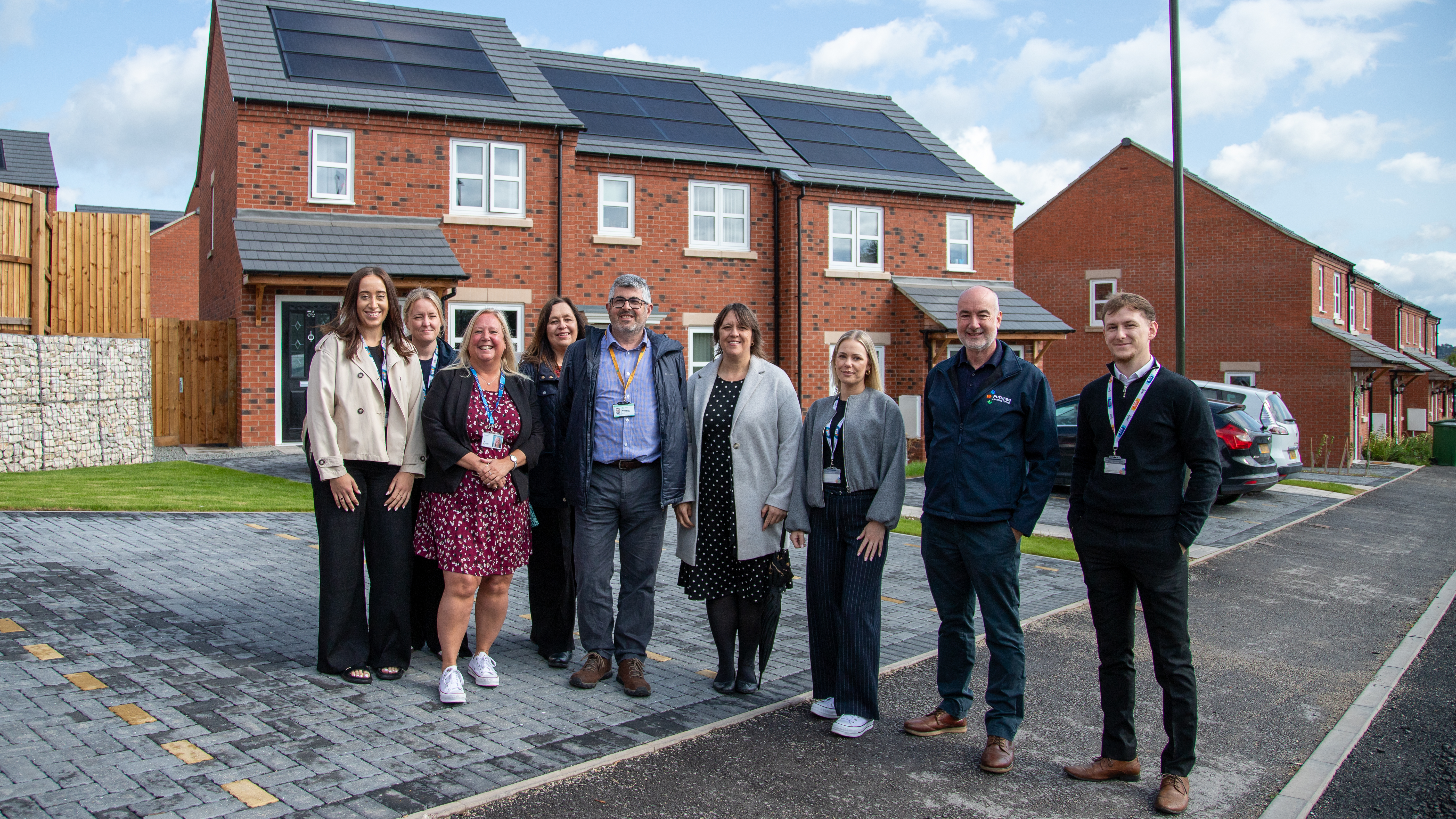 Futures and council colleagues outside a new home with solar panels on top