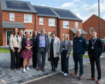 Futures and council colleagues outside a new home with solar panels on top