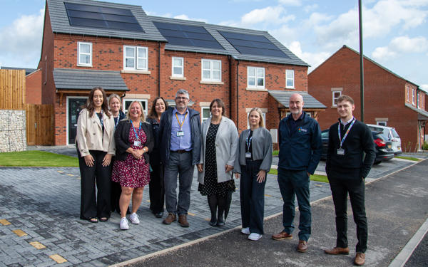 Futures and council colleagues outside a new home with solar panels on top