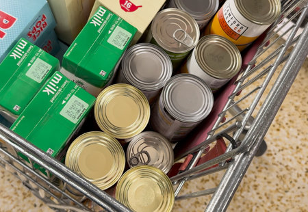 Shopping trolley with tinned items, cartons of milk and cereal