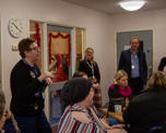 People listening to Jill speaking at a community centre