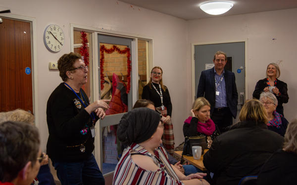 People listening to Jill speaking at a community centre